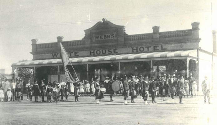 A street parade in front of the White House Hotel.